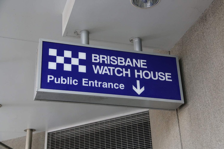 Blue sign of public entrance to Brisbane Watch House in Roma Street in Brisbane CBD.