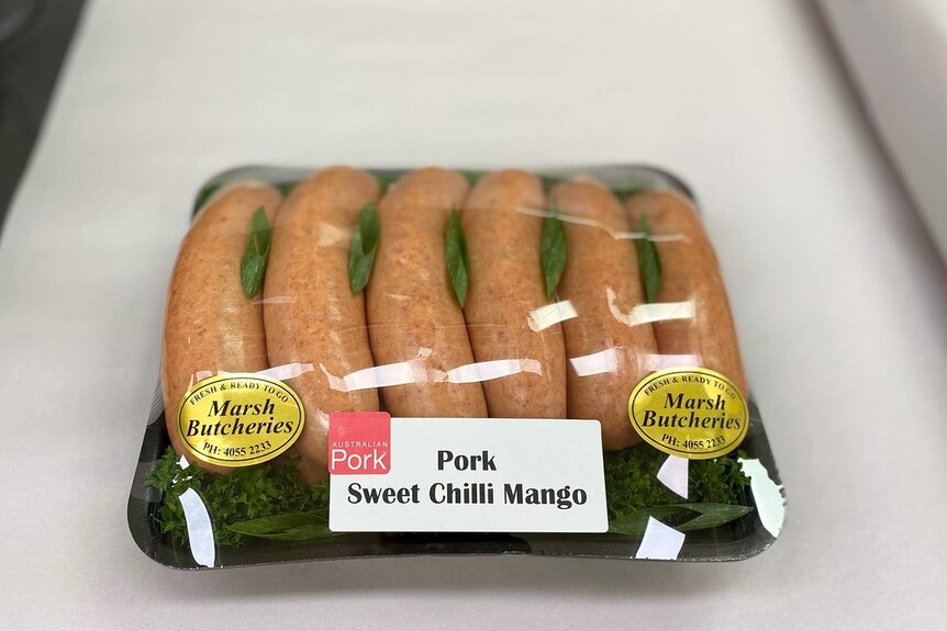 Half a dozen sausages packaged and labels Pork Sweet Chilli Mango