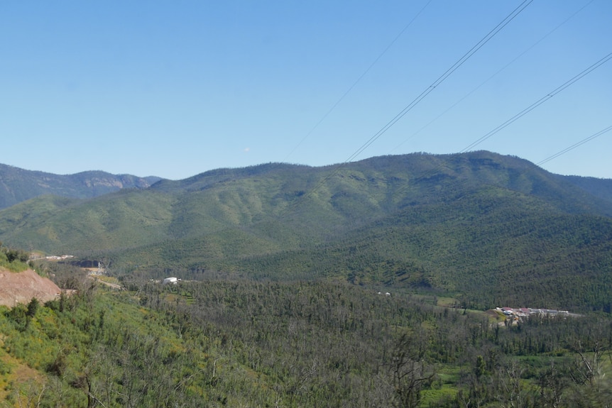 a view of a mountain range with a power line