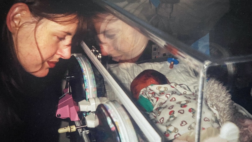 A young Kaz looks into newborn Oona's incubator.