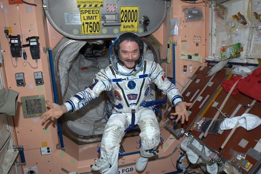 Chris Hadfield poses for a photo in his Sokhol pressure suit