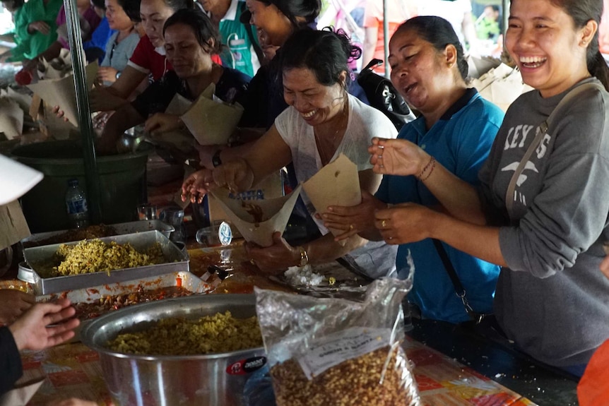 A group of people preparing meals