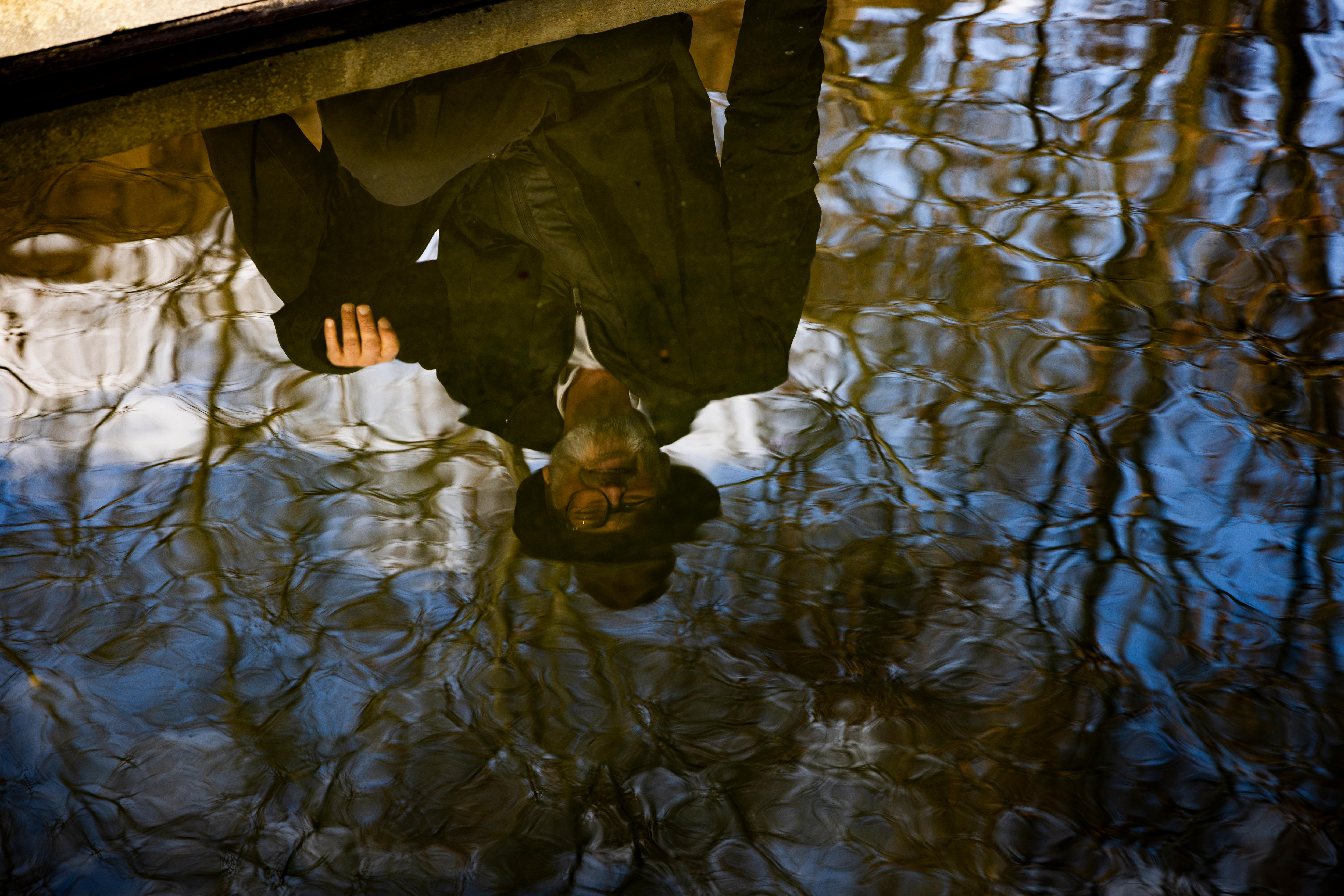 Grant Blashki's reflection can be seen in a body of water on a sunny day.