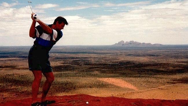 Man teeing off on top of Uluru