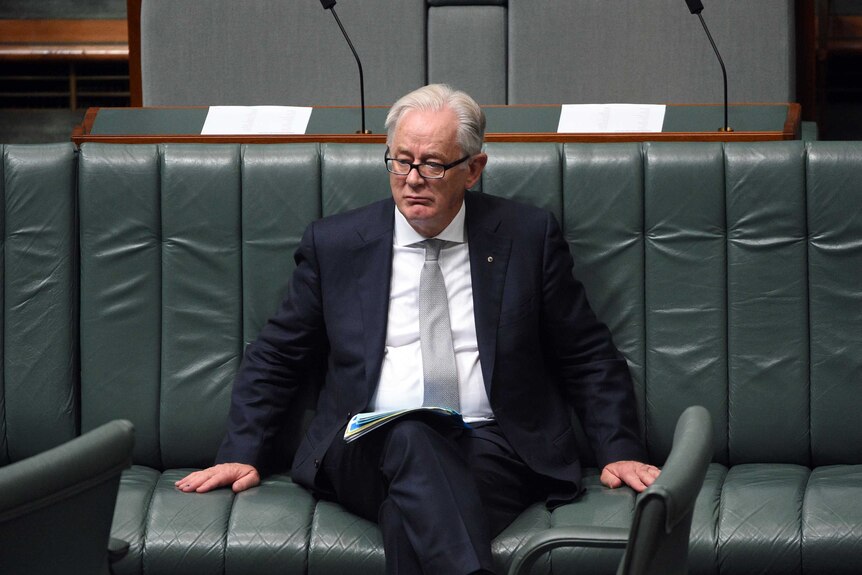 Andrew Robb sits on the bench in parliament