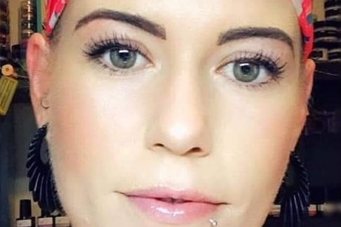 Toowoomba mum Jacinta Foulds stares into camera with head scarf