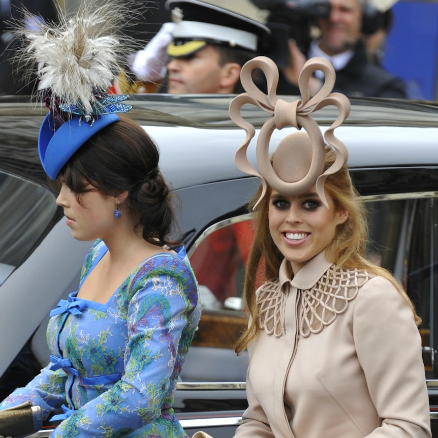 Two wedding guests in fancy hats