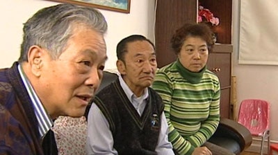 Members of the Ly family wait anxiously for news.
