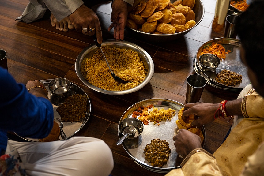 Jain breakfast being served on the floor.