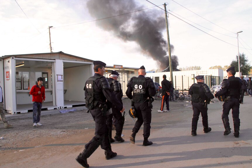 Plumes of black smoke fill the air at the Calais migrant camp