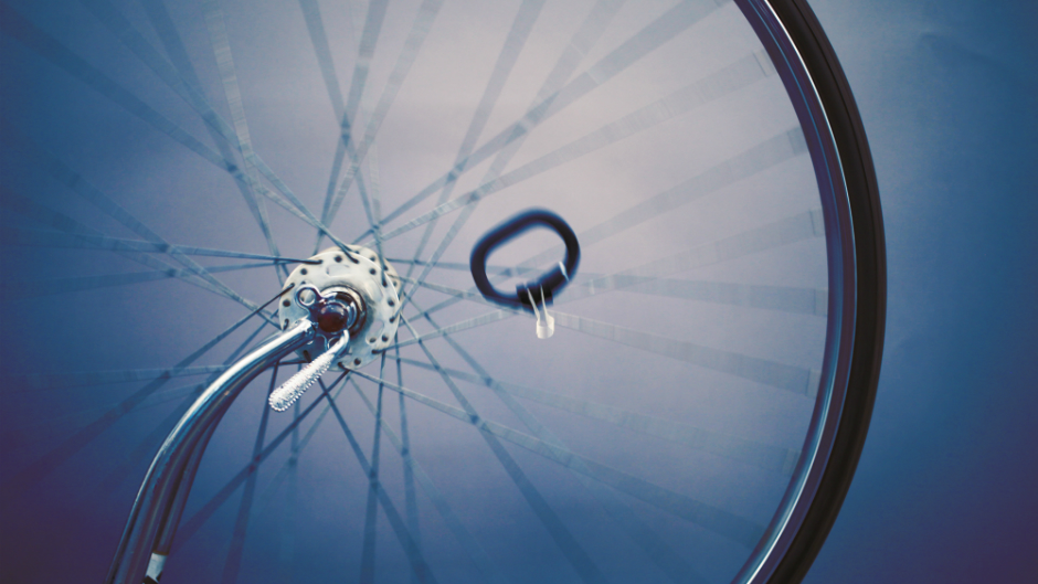A fitness tracking device attached to the wheel of a bike.