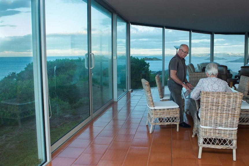 Lance and Toni Hingston in their lounge with amazing coastal views.