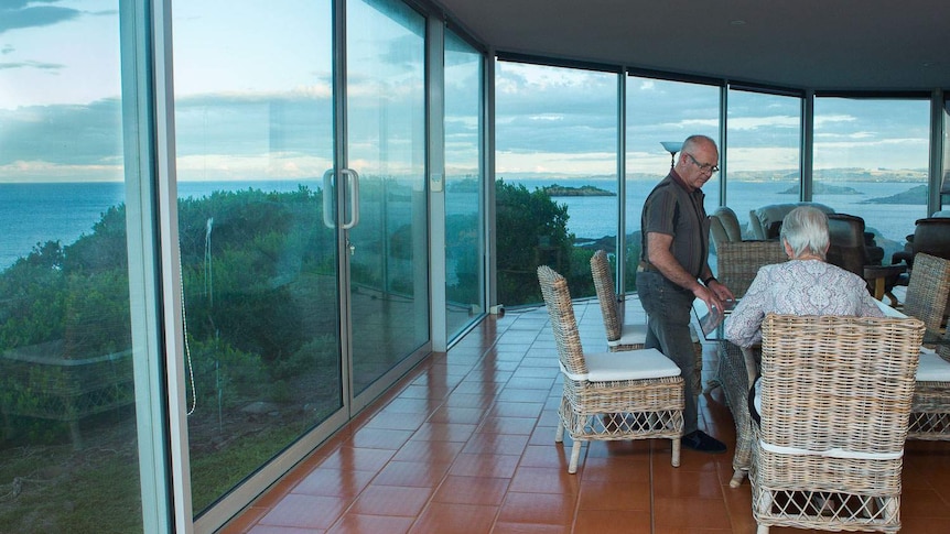 Lance and Toni Hingston in their lounge with amazing coastal views.