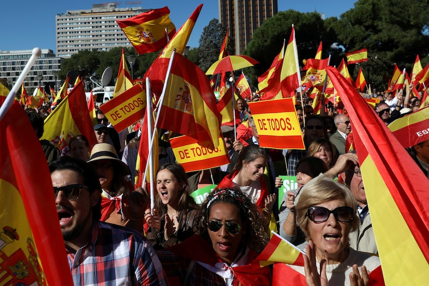 Nationalist activists march in Barcelona in a mass rally against Catalonia's declaration of independence
