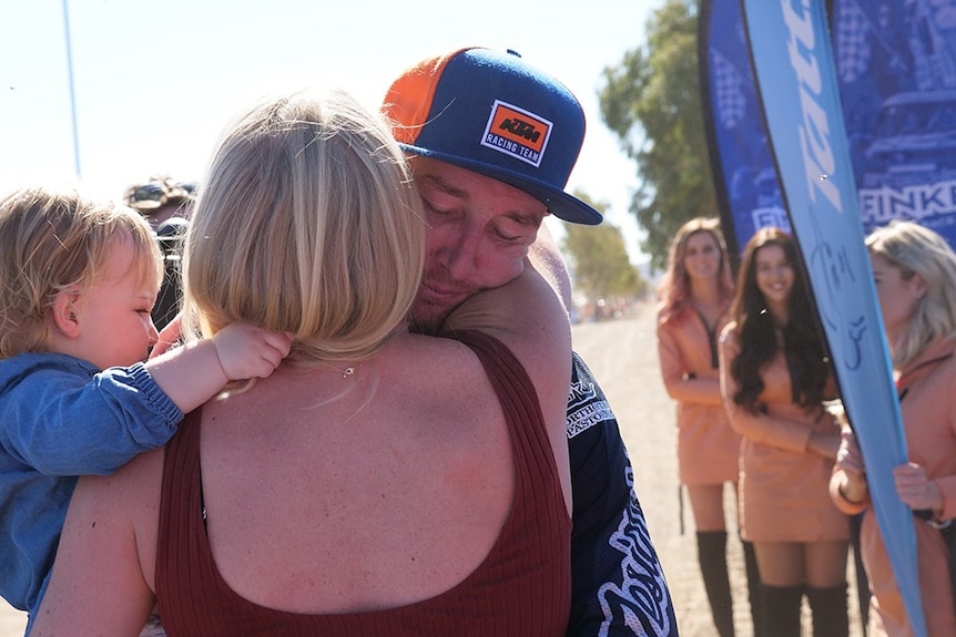 Newly crowned Finke King of the Desert, David Walsh, hugs his wife after the victory.