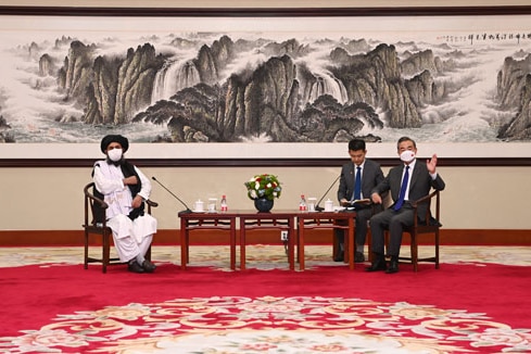 Abdul Ghani Baradar of the Afghan Taliban sits with Wang Yi.