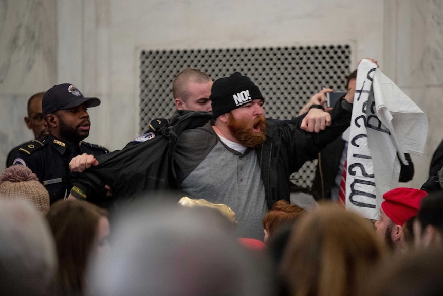 A protester is removed at Jeff Sessions' confirmation hearing