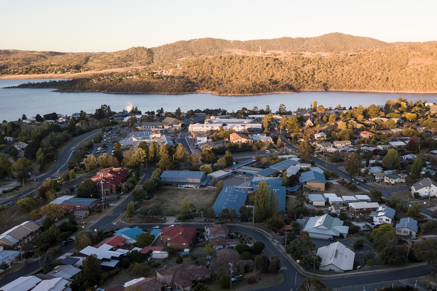 A drone shot of a regional town centre by a river.