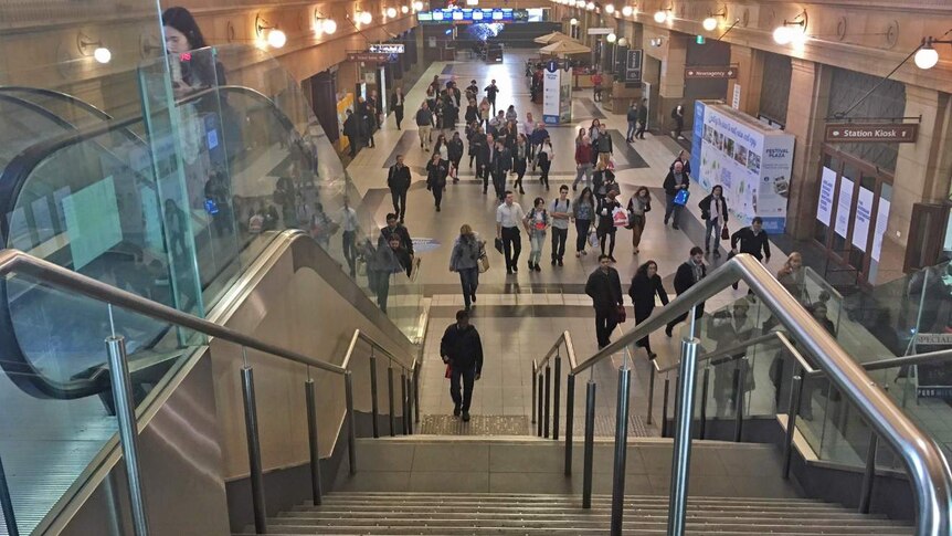 commuters walk through the concourse of Adelaide railway station.