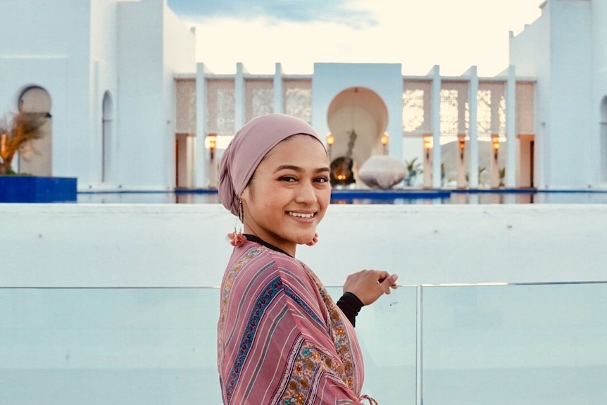 Intan Endah-Bonsu smiling at the camera wearing a blush pink chiffon scarf.