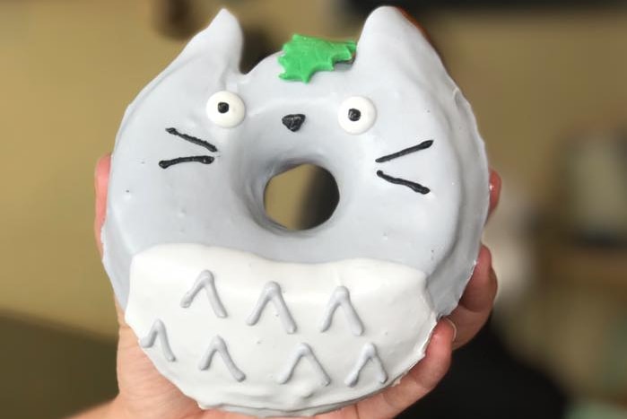 A doughnut designed in the shape and colour of Totoro from Studio Ghibli.