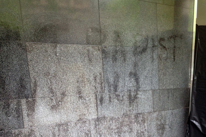 Abusive graffiti on the wall of the County Court building in Melbourne.