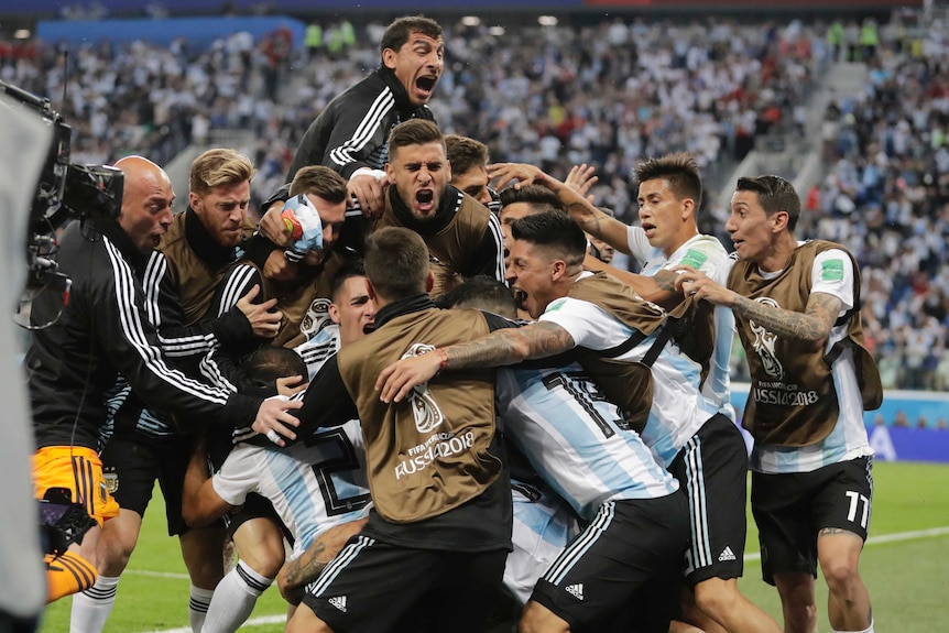 Argentina's players pile on top of each other to celebrate goal