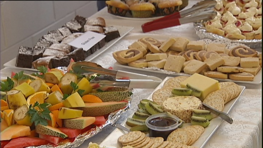 Video still: Party food on table with tongs for food safety. Generic