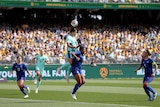 Sam Kerr jumps up for headbutt at ball in soccer game
