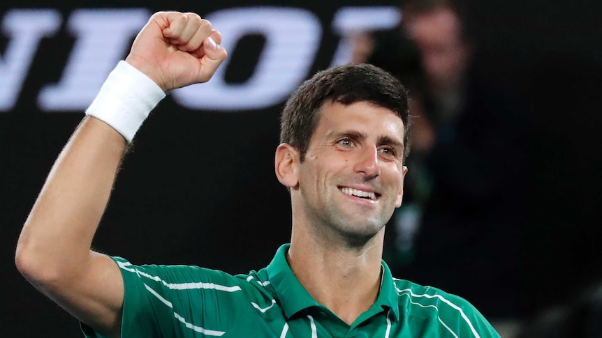 A tennis player pumps his fist in victory after winning the Australian Open.