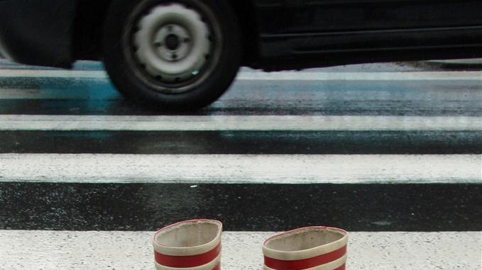 Red gumboots on pedestrian crossing