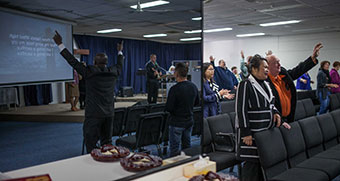 Worshippers attend a service in a hall.