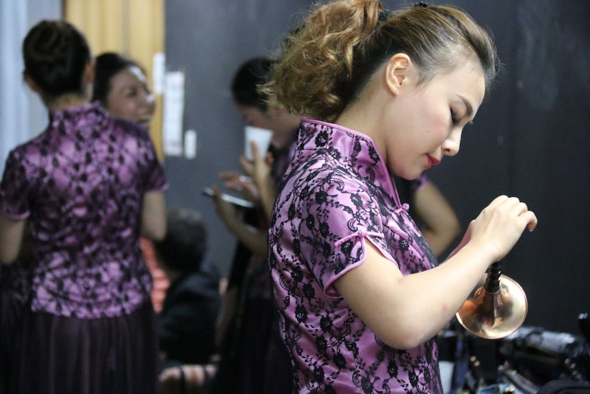 A soloist from a Chinese folk orchestra prepares backstage at the Federation Concert Hall, Hobart.