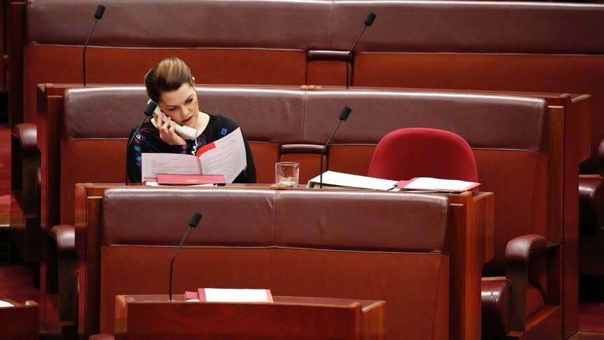 Greens Senator Sarah Hanson-Young speaks on phone in Senate chamber