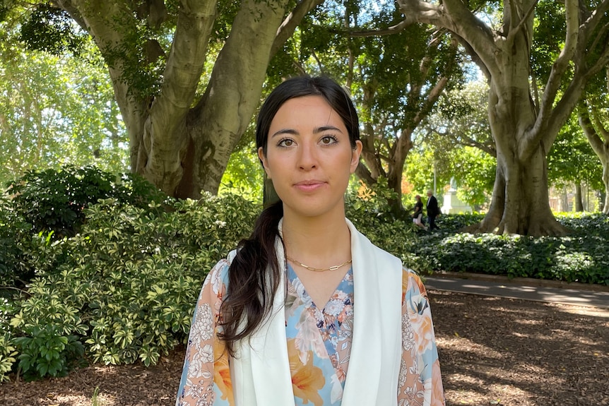 Inty Elham poses for the camera at an outdoor event in Sydney. 