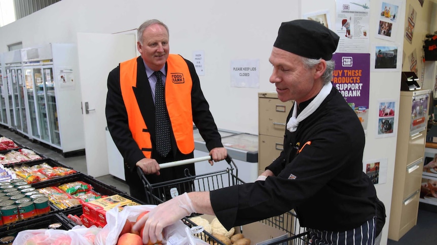 Foodbank Tasmania chief Ed Gauden with a trolley.