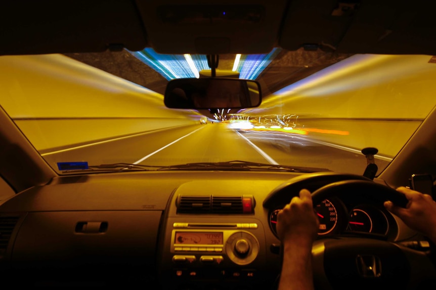 The view of toll road tunnel in Queensland from inside a car.