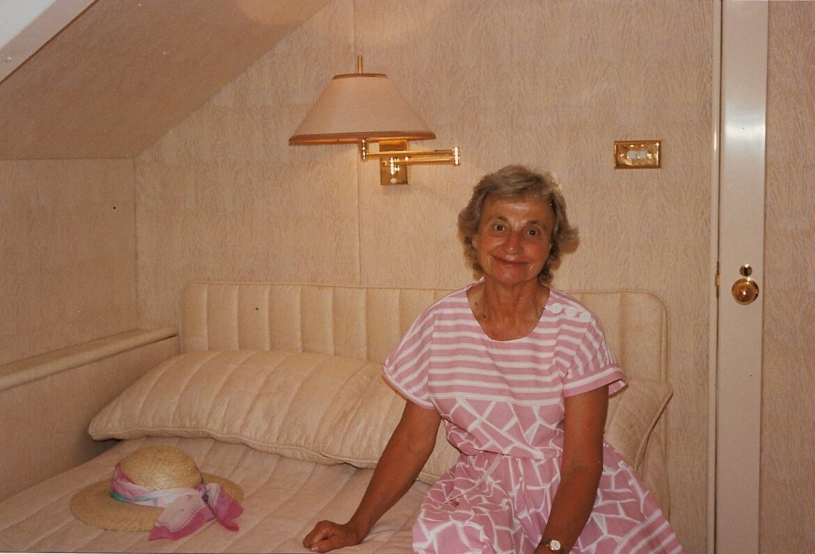 A woman sits on a bed