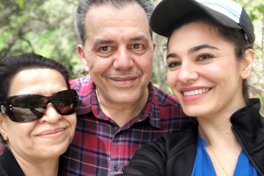 a family at a park smiling 