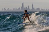 A young surfer catches a wave on the Gold Coast