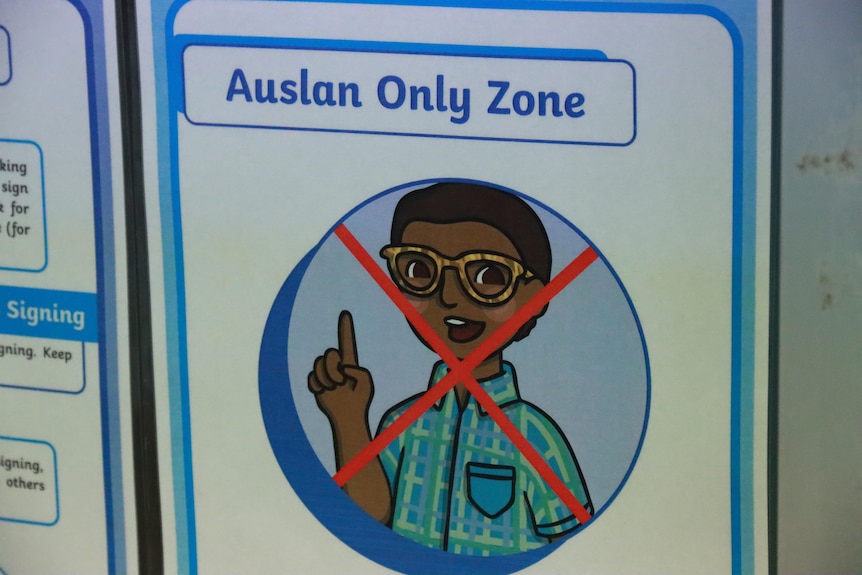 A sign on the wall that says "Auslan only zone"
