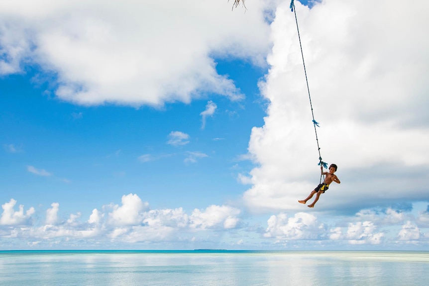 Kiribati kid on a swing