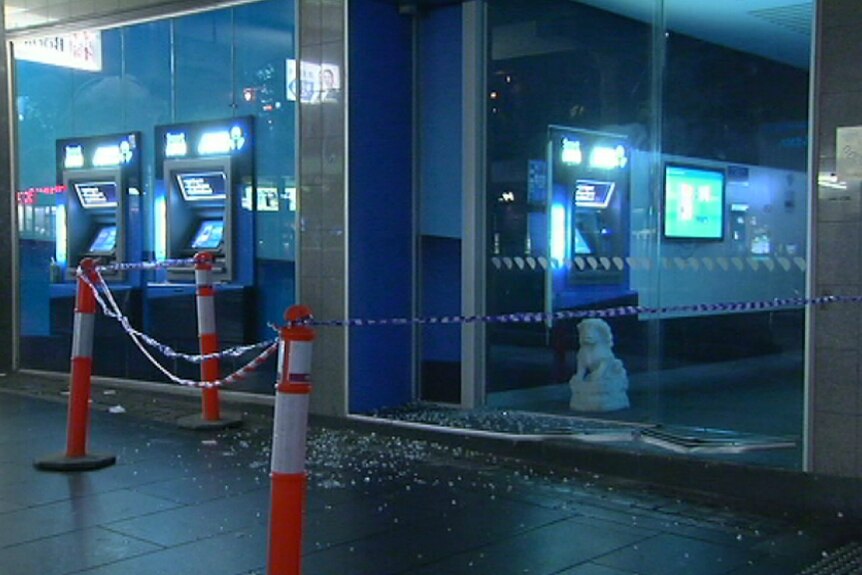 Orange cones around shattered glass in the doorway of a bank in Melbourne after a driver crashed into the front door.