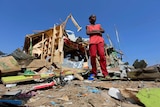 A boy outside the wreckage of his shop in Mogadishu after a bomb blast.