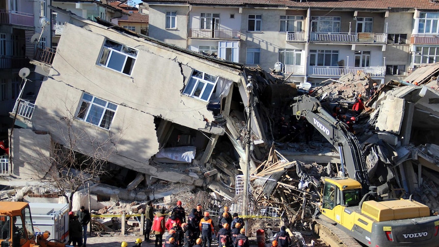 Rescuers work on a collapsed building after a strong earthquake struck in Elazig, Turkey.