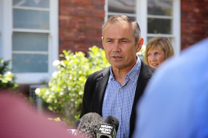 Health Minister Roger Cook stands at a press conference in front of King Edward Memorial Hospital.