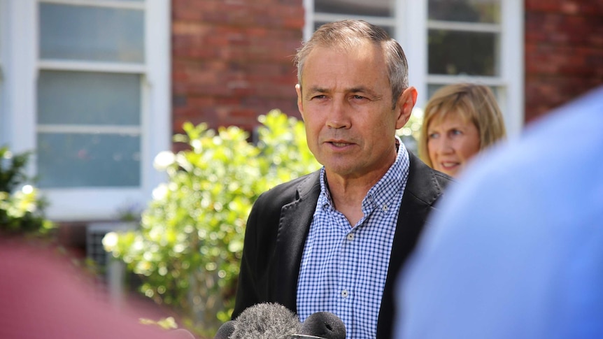 Health Minister Roger Cook stands at a press conference in front of King Edward Memorial Hospital.