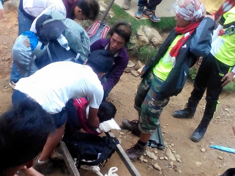 Local Mount Kinabalu guides attend to injured