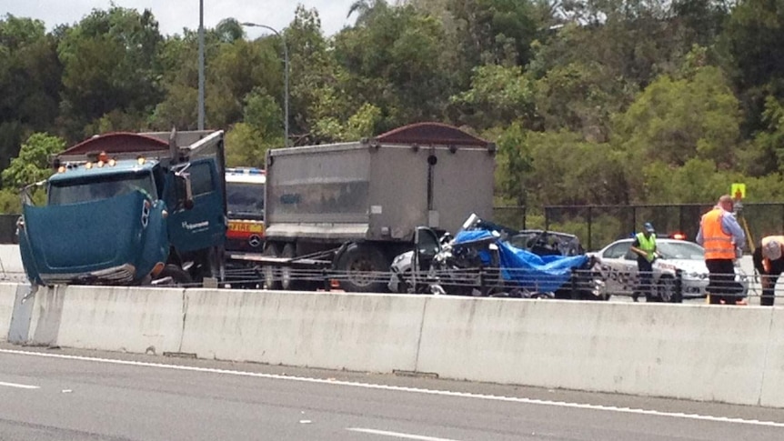 Two people died when this car and truck collided on the southbound side of the Pacific Motorway.