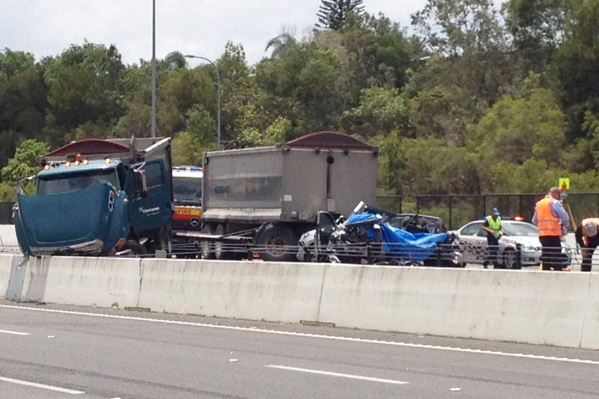 Two people died when this car and truck collided on the southbound side of the Pacific Motorway.